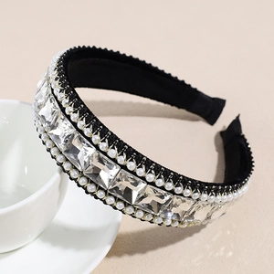 Close-up of baroque wide headband featuring large square crystals and pearl embellishments
