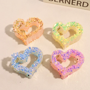 Star-patterned heart hair claw clips in orange, green, blue, and purple set