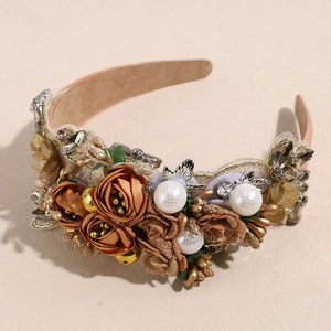 Macro shot of baroque headband with satin roses, pearls, and rhinestones