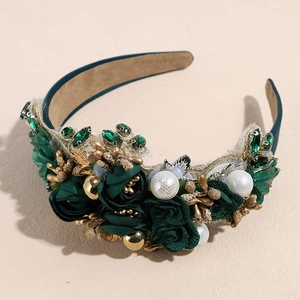 Detailed macro view of baroque headband featuring velvet roses and emerald rhinestones