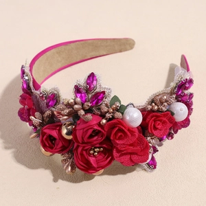 Detailed macro view of baroque headband featuring red fabric roses and rhinestones