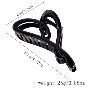 Detail view of a large black heart-shaped hair claw clip with size dimensions shown