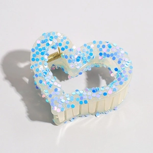 Detail of heart hair claw clip with blue and purple sequins and gold metal spring