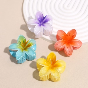 Set of four colorful floral resin hair claws in purple orange blue and yellow for women