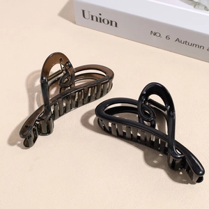 Elegant heart-shaped large hair claw clips in glossy black and amber colors
