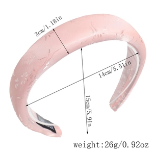 Detail showing dimension markings on a pink satin padded headband with floral pattern