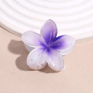 Detailed macro view of a purple and white gradient plumeria flower hair claw clip