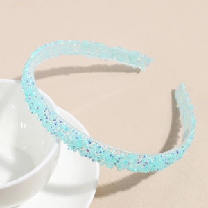Gros plan du serre-tête bleu clair orné de strass et perles de cristal sur une tasse