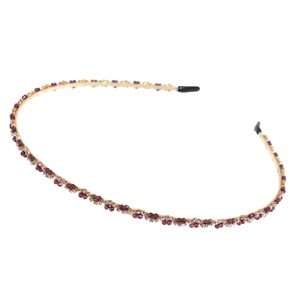Elegant thin gold headband with purple and white crystals on a white background
