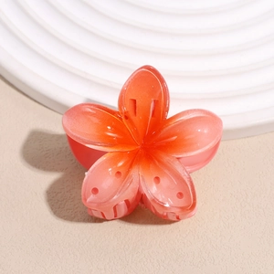 Detail of gradient orange flower hair claw clip with pearlescent resin petals