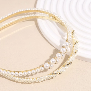 Double-layered gold headband featuring elegant white pearls and sparkling rhinestones