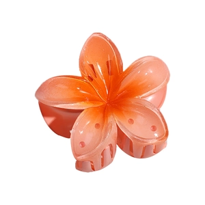 Gradient orange tropical flower hair claw clip made of translucent resin on white background