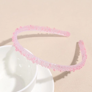 Détail du serre-tête rose avec strass et texture bulles sur une tasse en céramique