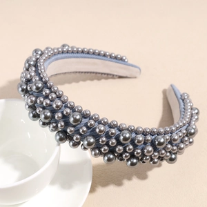 Detail of dark grey mixed-size pearls on a wide padded headband with fabric texture