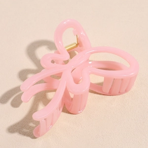 Detail of pink jelly butterfly hair claw clip with golden metal spring mechanism