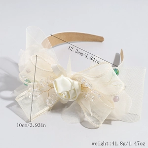 Close-up of cream mesh bow headband with rose detail and dimensions 12.3cm by 10cm