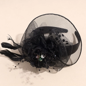 Detail of vintage black mesh bridal fascinator with feathers and emerald beads