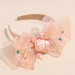 Detail of peach mesh headband with handmade satin rose and crystal bead accents