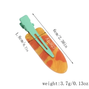 Detailed view of resin duckbill hair clip with orange marble pattern and size markings