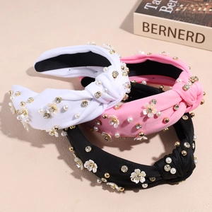 Cerchietti in tessuto annodato con fiori, perle e strass in tre diversi colori alla moda