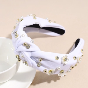 Dettaglio di cerchietto in tessuto bianco con perle, cristalli e fiori 3D raffinati