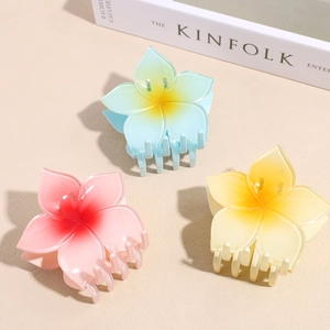 Three-piece plumeria flower hair claws in gradient resin colors for elegant hair styling
