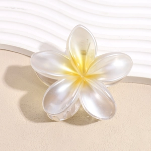 Dettaglio ravvicinato della molletta a forma di plumeria con petali opachi e sfumati