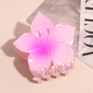 Macro detail of gradient pink resin plumeria claw clip showing durable smooth teeth