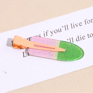 Detail of pink and green ice cream shaped hair clip with glitter and matte metal duckbill base