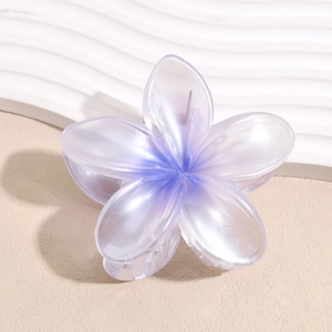 Dettaglio macro della pinza per capelli plumeria viola sfumata con finitura in resina perlata