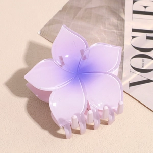 Detail view of purple frangipani flower hair claw clip with glossy resin finish