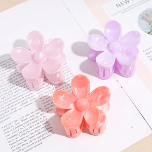 Three-piece floral hair claw clip set with marble pearl finish in pink, purple, and orange