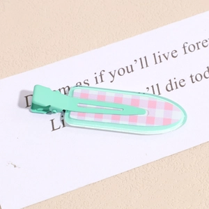 Detail view of mint green and pink checkered hair clip with metal duckbill clamp