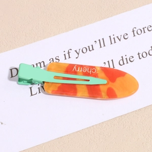 Detail of jelly marble texture hair clip with mint green base and cherry text engraving