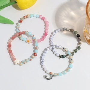 Set of four handmade crystal beaded bracelets with moon and star metal charms