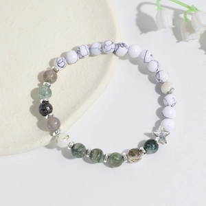 Macro shot of handmade crystal beaded bracelet with turquoise and star metal pendant