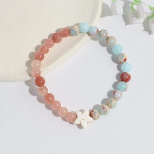 Close-up of handmade crystal beaded bracelet with pink stones and star charm