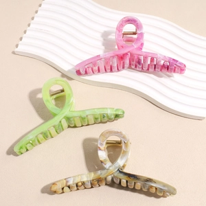 Large marble texture shark hair claws in pink, green, and amber for elegant hair styling