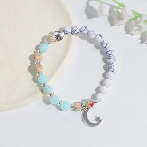 Handmade beaded bracelet with turquoise stones, silver heart bead and moon star charm