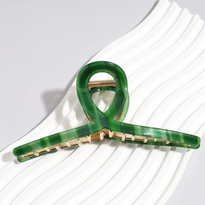 Detail of 13cm dark green marble hair claw clip with golden metal teeth for thick hair