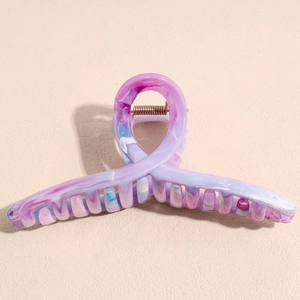 Macro shot of large purple marble textured hair claw clip with glossy acrylic finish