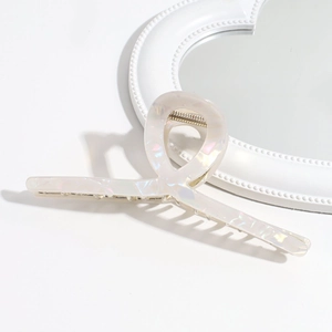 Close-up of 13cm oversized cream hair claw with iridescent mother of pearl finish