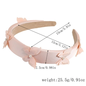 Detail of padded bow headband with pearls in beige satin for high crown hair styling