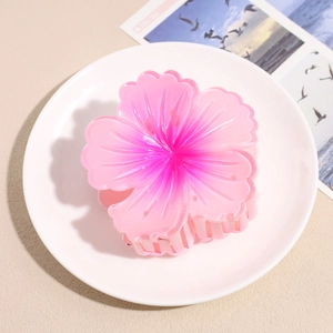 Detailed macro view of a large gradient pink resin flower claw clip with realistic petals