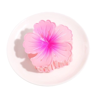 Pink gradient frangipani flower hair claw clip on white plate for elegant hairstyles