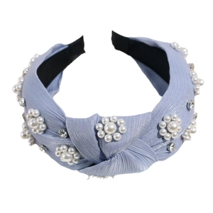 Light blue knotted headband with pearl flower patterns and sparkling rhinestones