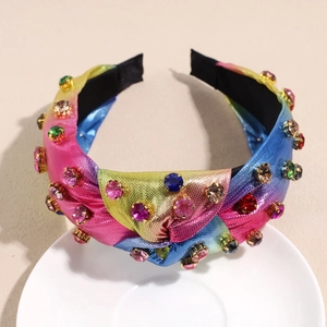 Detailed close-up of rainbow gradient knotted headband with shiny rhinestones and crystals