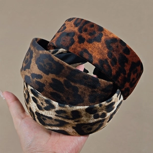 Three leopard print velvet wide headbands in brown, tan, and cream tones for women
