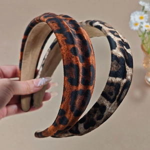 Chic leopard print velvet padded headbands in warm orange and cool grey tones