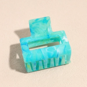 Detail view of the rectangular hair claw clip with blue marble pattern and matte finish